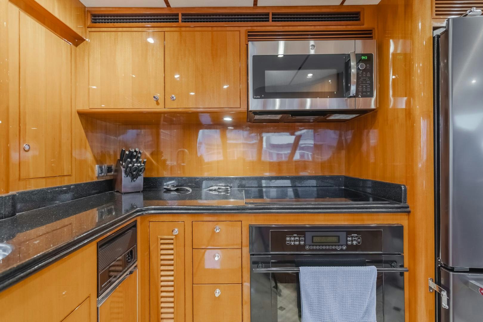 a kitchen with wooden cabinets aboard OBSESSION Yacht for Sale