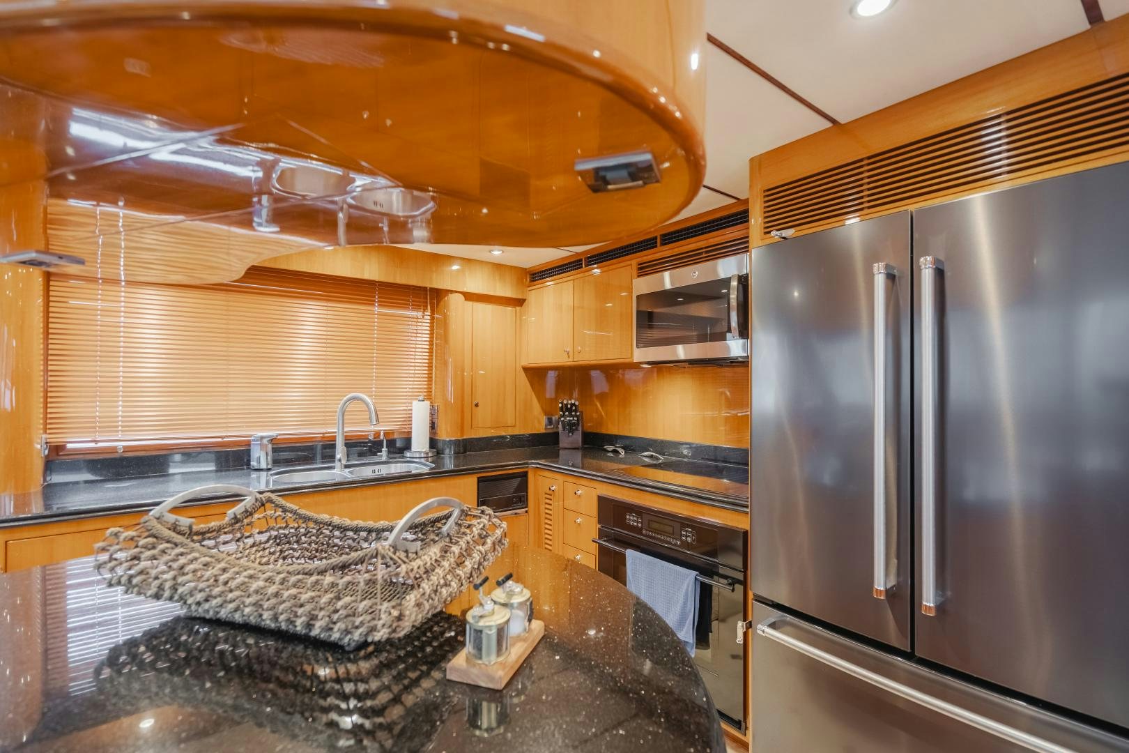 a kitchen with a large stainless steel refrigerator aboard OBSESSION Yacht for Sale
