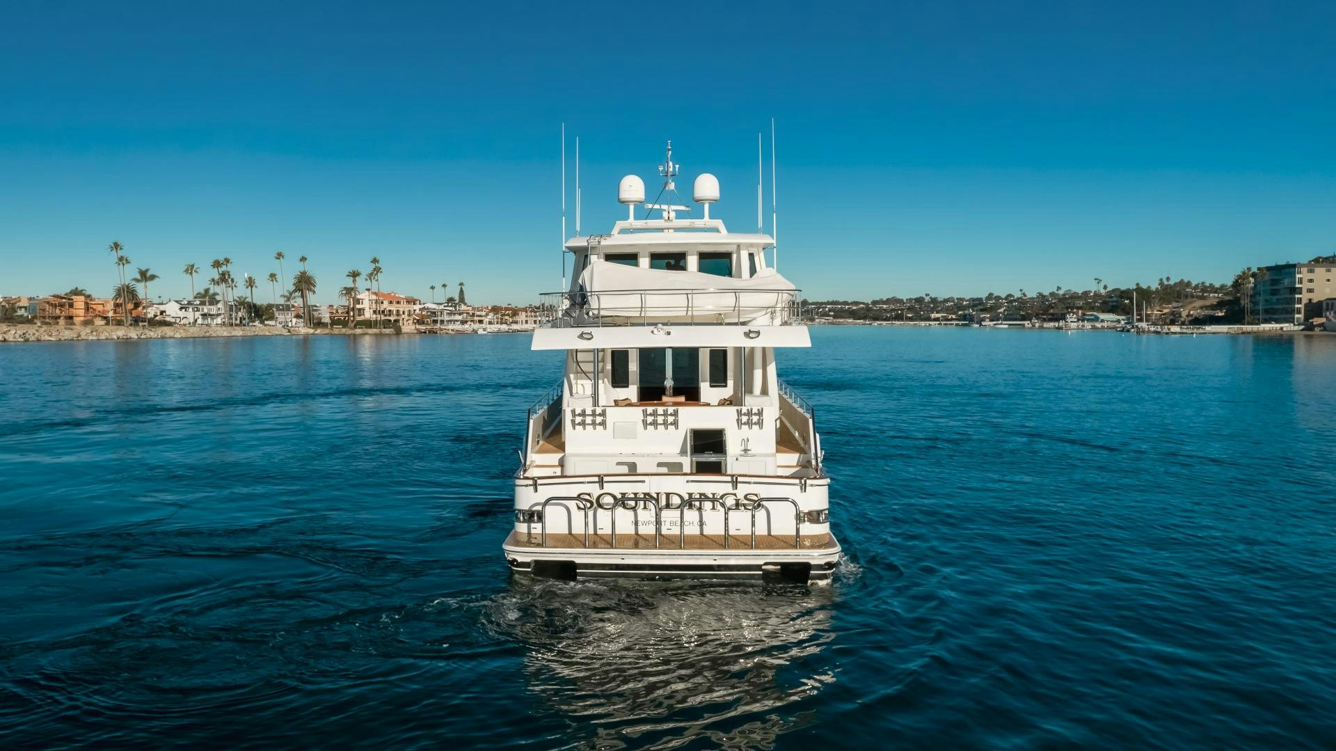 a white boat in the water aboard OBSESSION Yacht for Sale