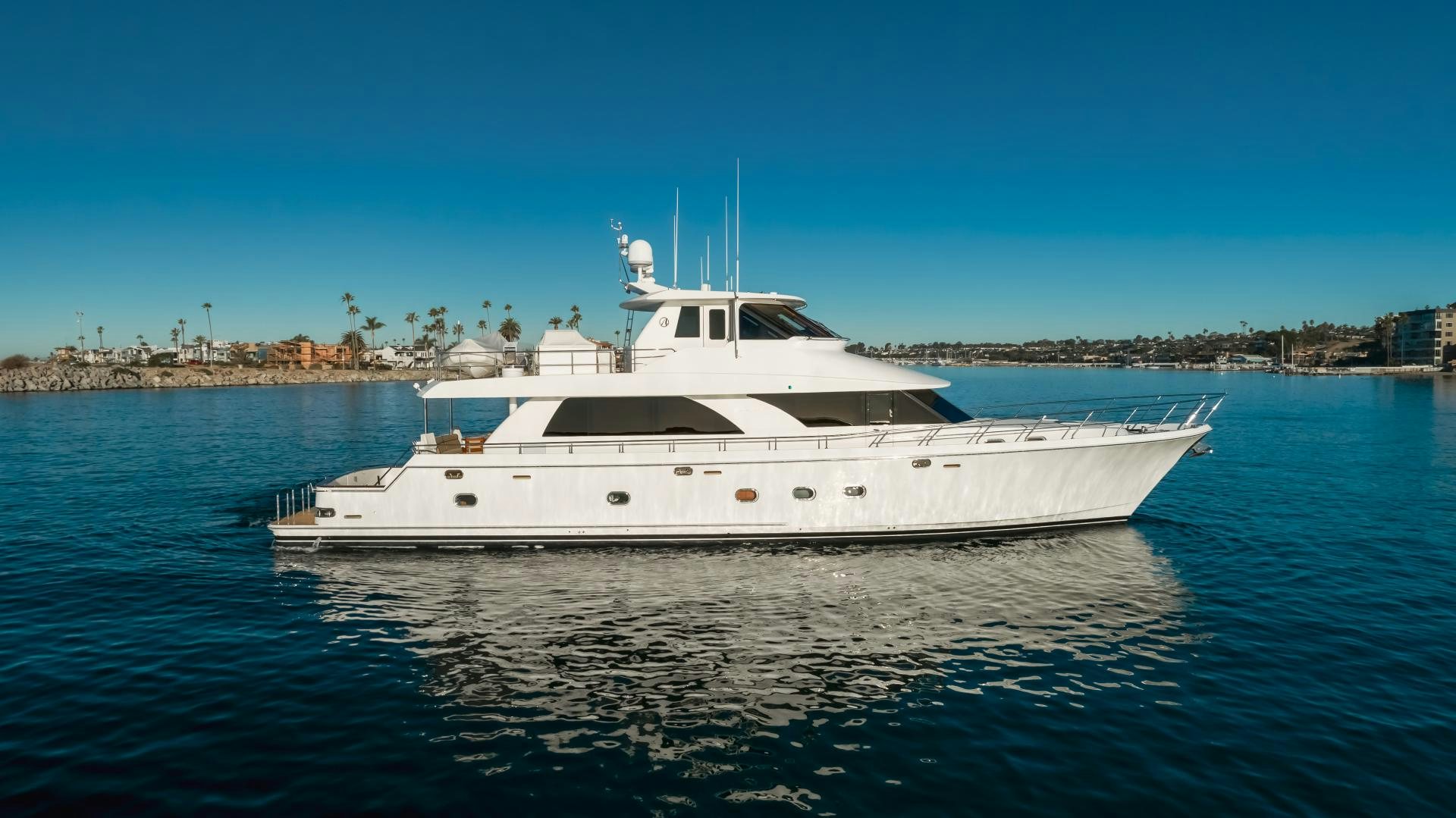 a white yacht in the water aboard OBSESSION Yacht for Sale