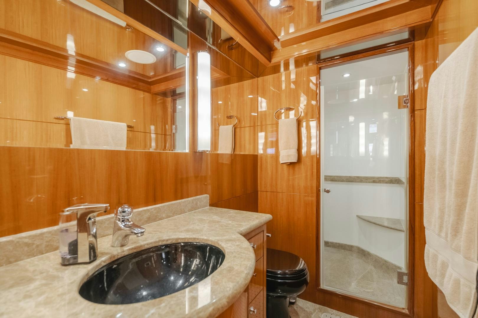 a bathroom with a sink and a shower aboard OBSESSION Yacht for Sale