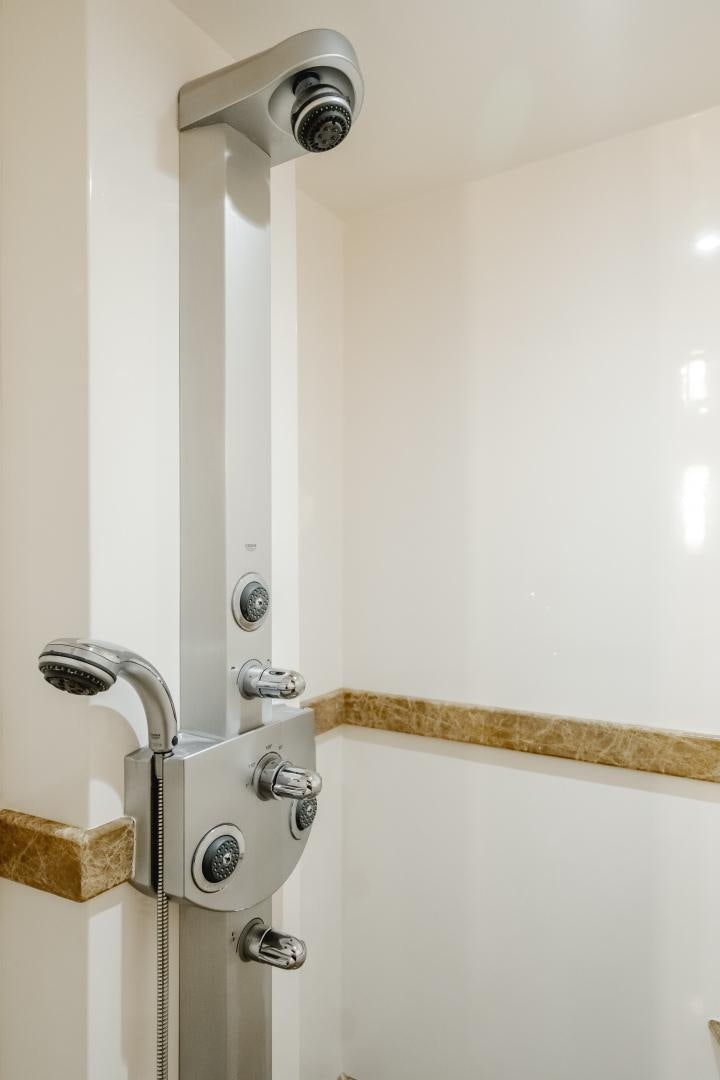 a shower with a wooden handle aboard OBSESSION Yacht for Sale