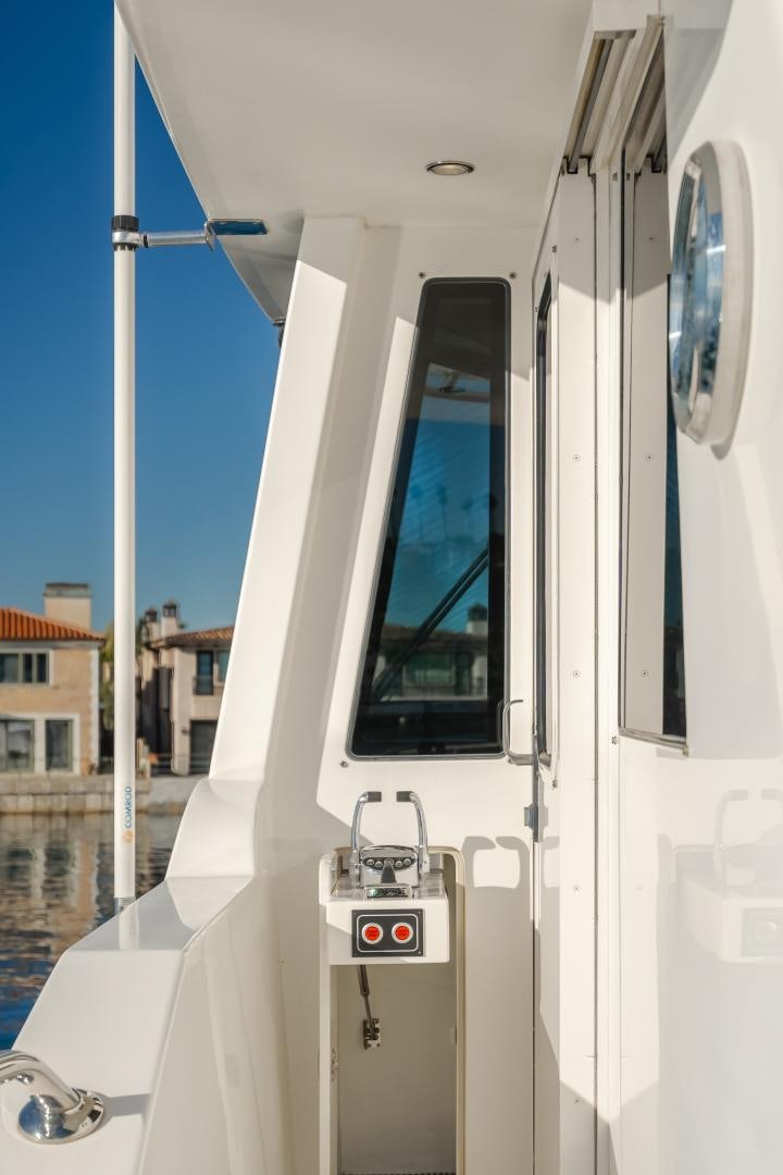 a white boat with red lights aboard OBSESSION Yacht for Sale