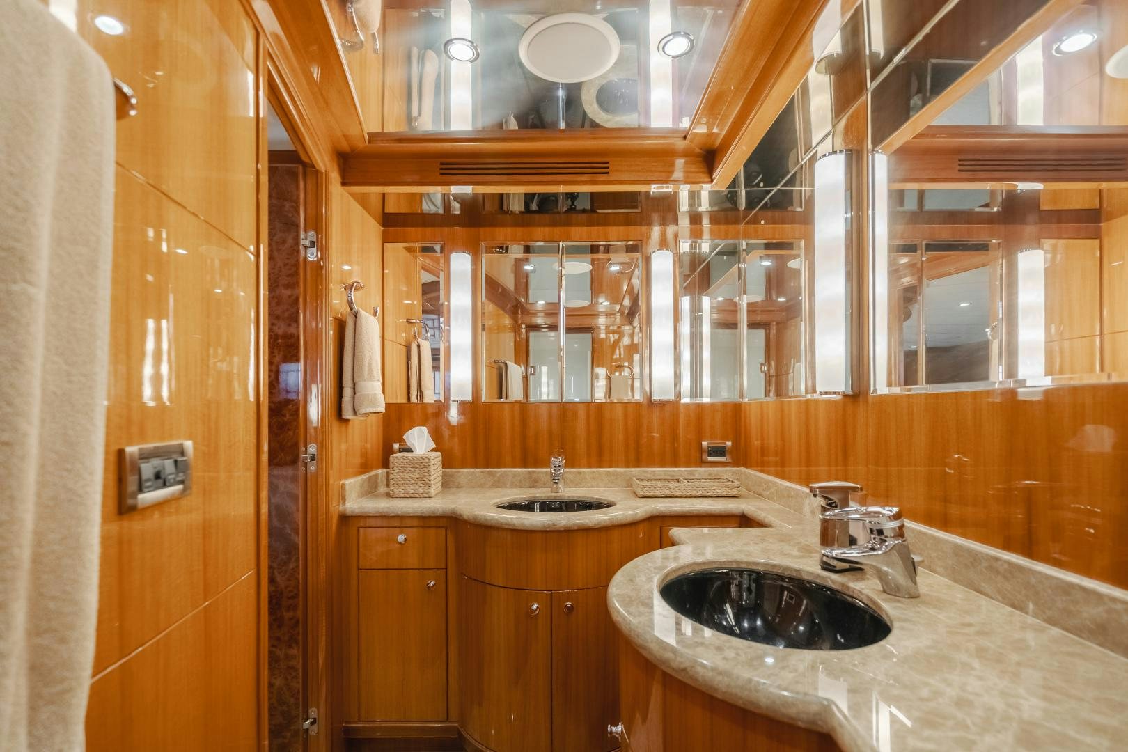 a bathroom with a sink and a mirror aboard OBSESSION Yacht for Sale