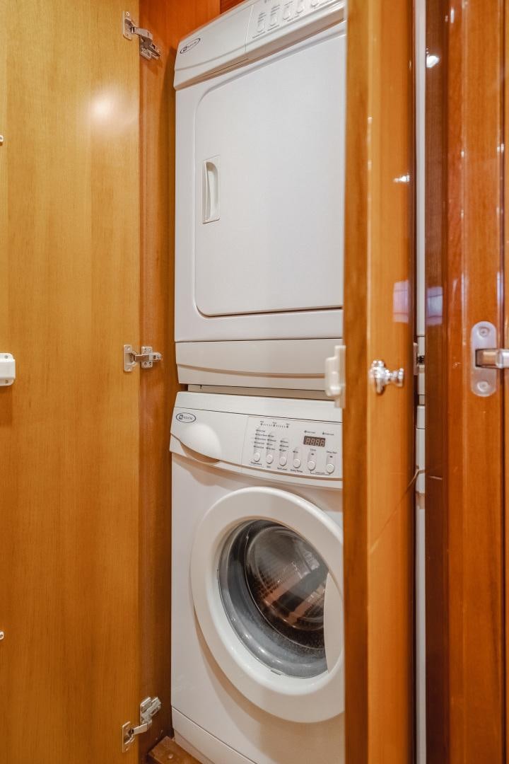 a closet with washer and dryer aboard OBSESSION Yacht for Sale
