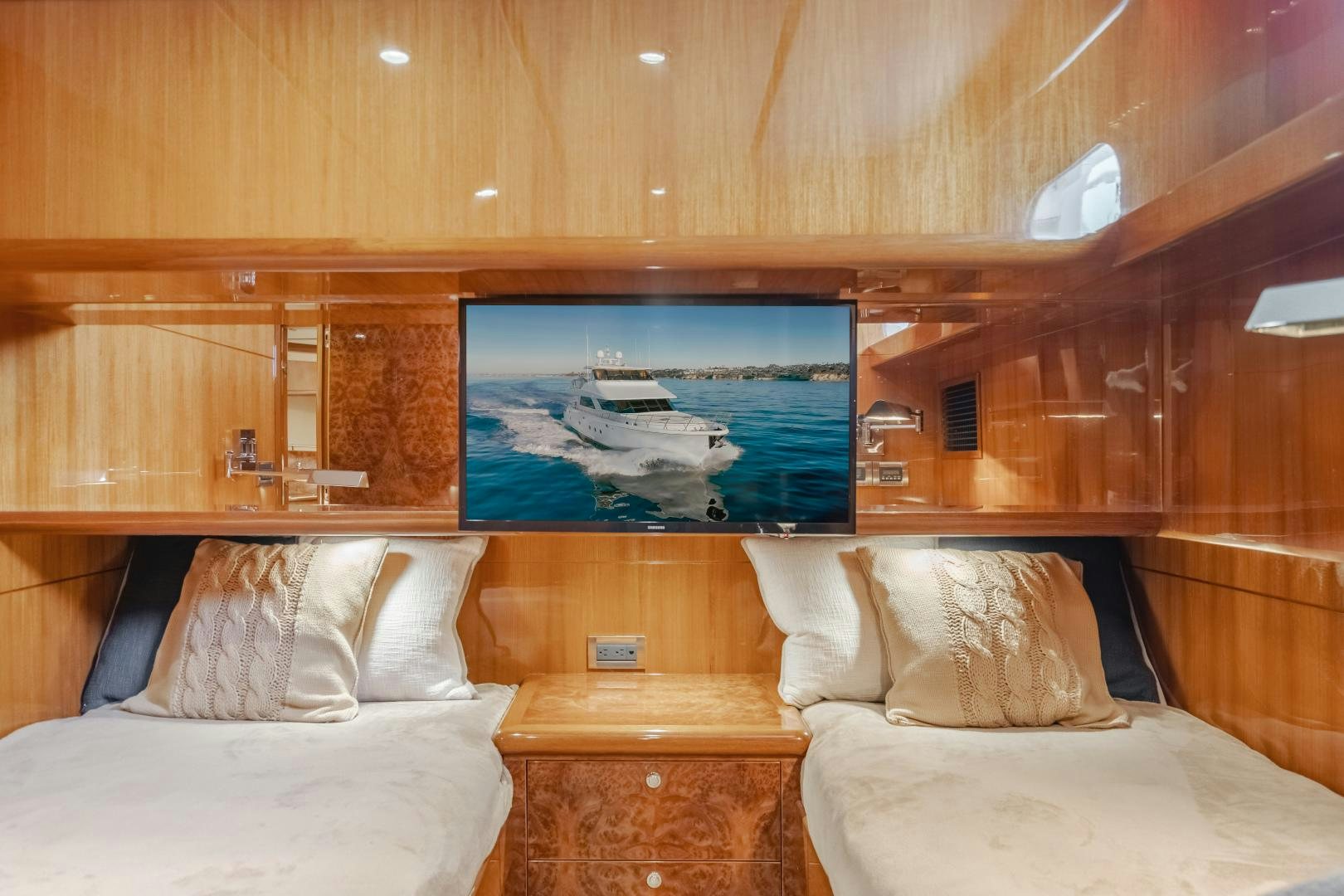 a room with a bed and a television aboard OBSESSION Yacht for Sale