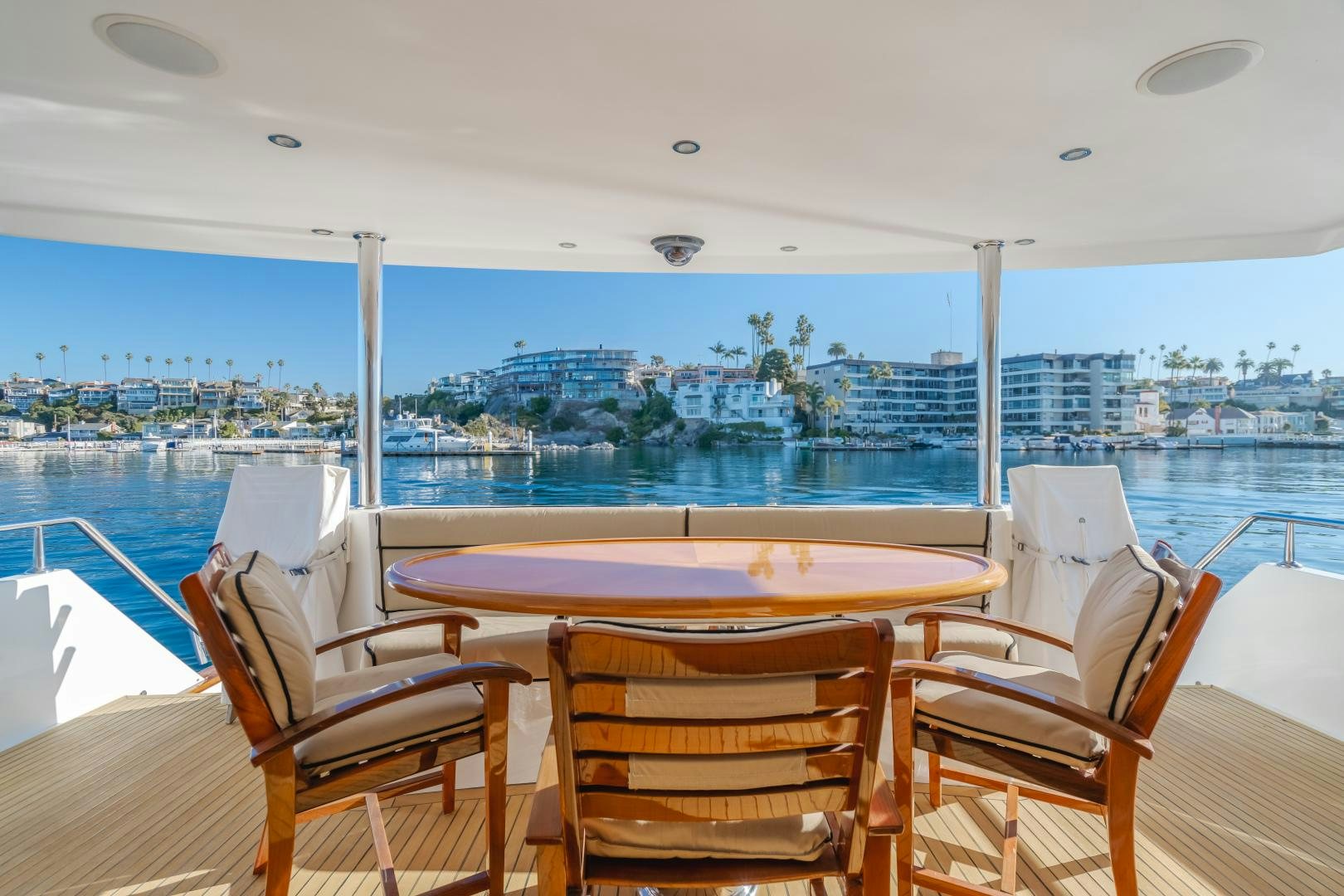 a table and chairs on a deck overlooking a city aboard OBSESSION Yacht for Sale