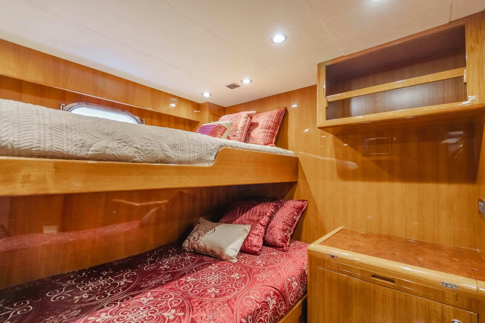 a bed with pink pillows aboard OBSESSION Yacht for Sale