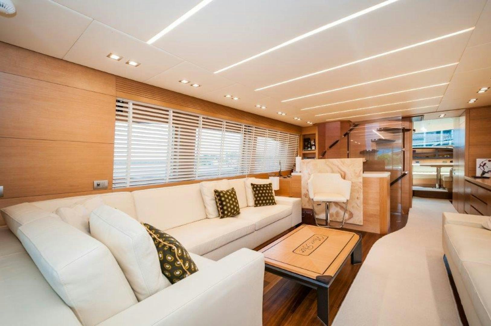 a living room with a couch and a table aboard NEVER REST Yacht for Sale