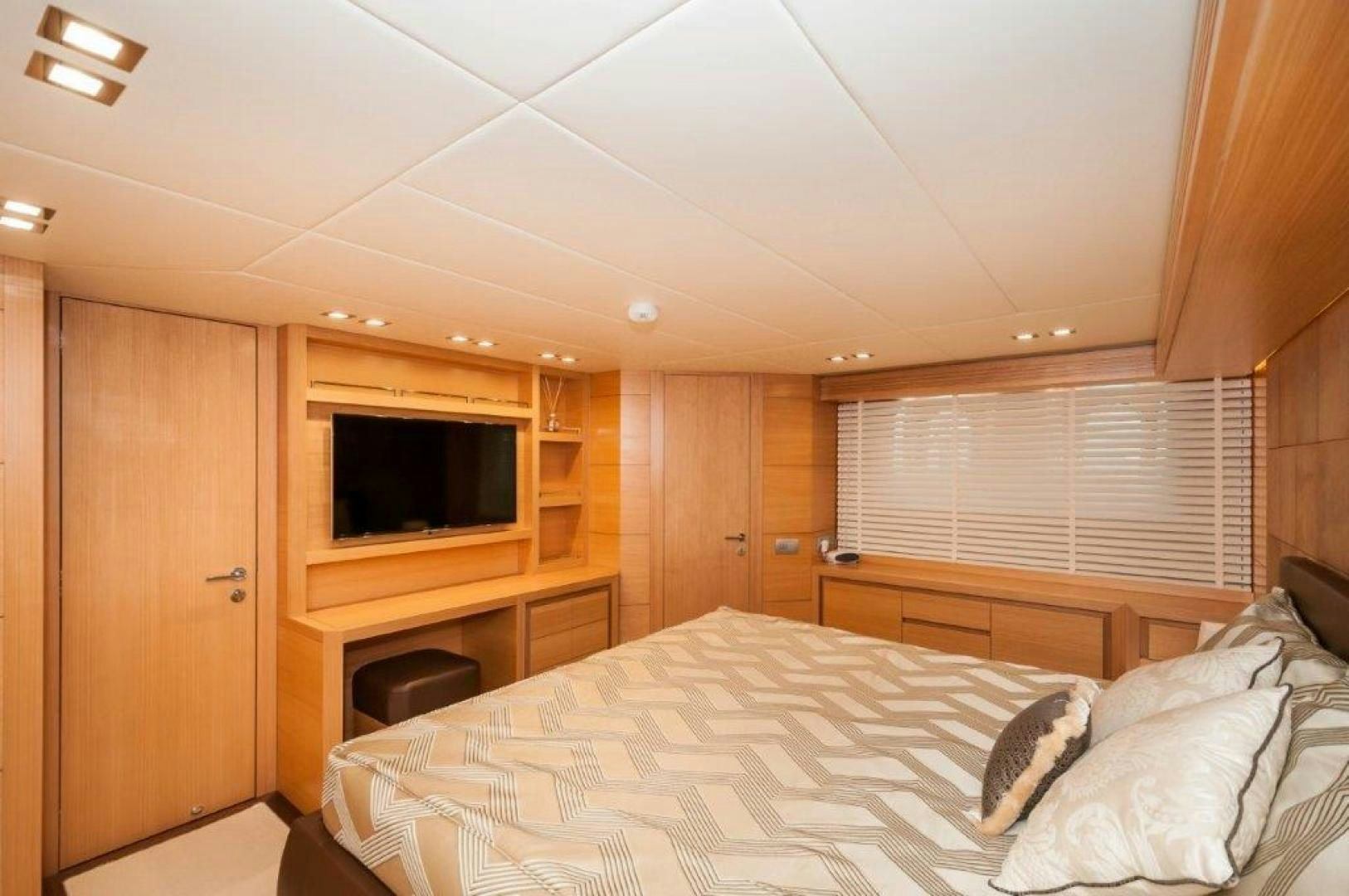 a bedroom with a bed and a television aboard NEVER REST Yacht for Sale