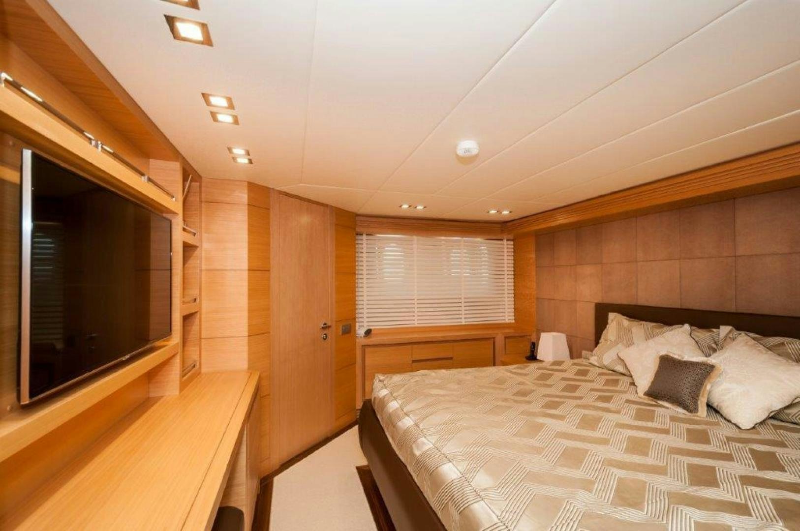a bedroom with a bed and a window aboard NEVER REST Yacht for Sale