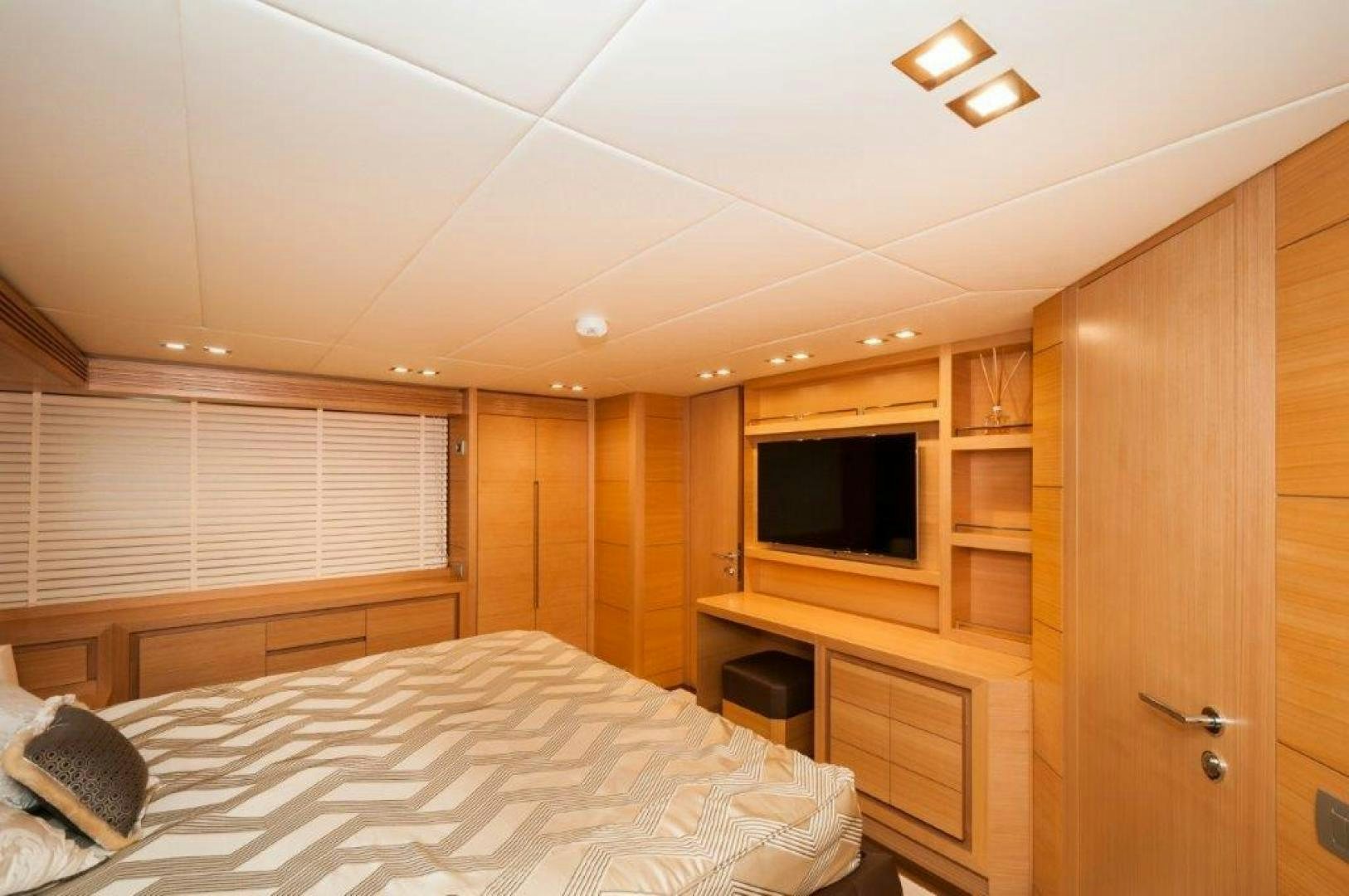 a bedroom with a bed and a television aboard NEVER REST Yacht for Sale