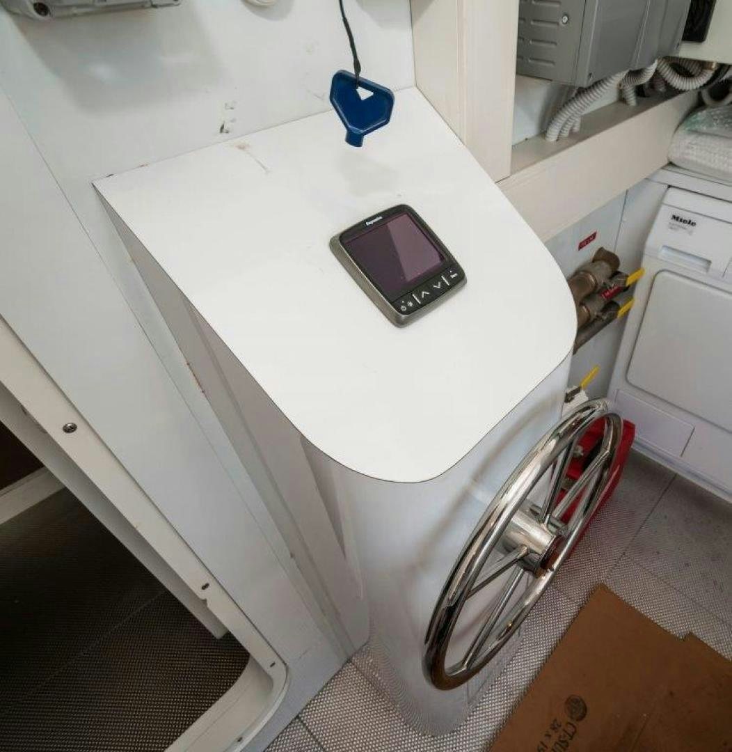 a cell phone on a refrigerator aboard NEVER REST Yacht for Sale
