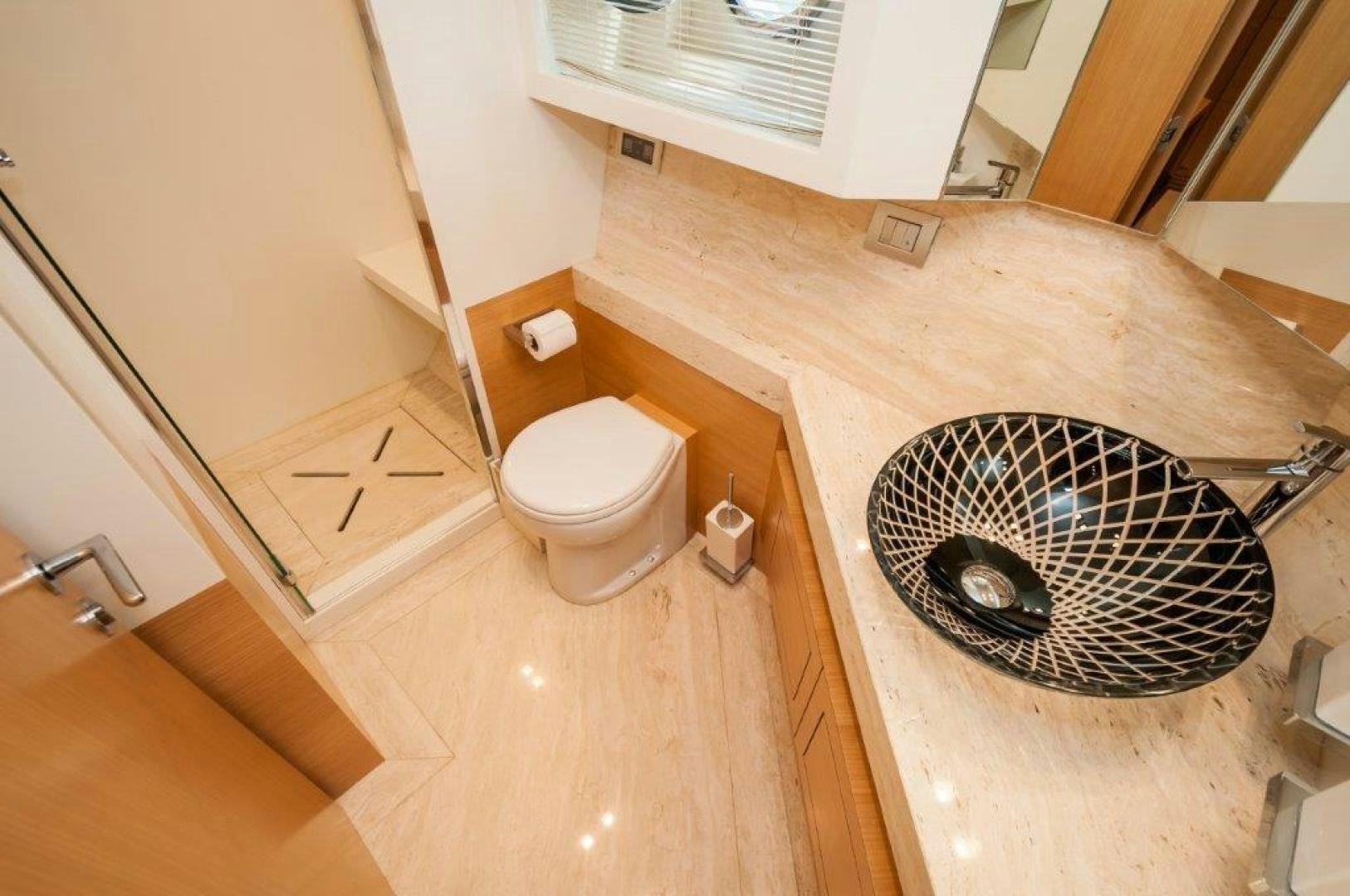 a bathroom with a toilet and a sink aboard NEVER REST Yacht for Sale