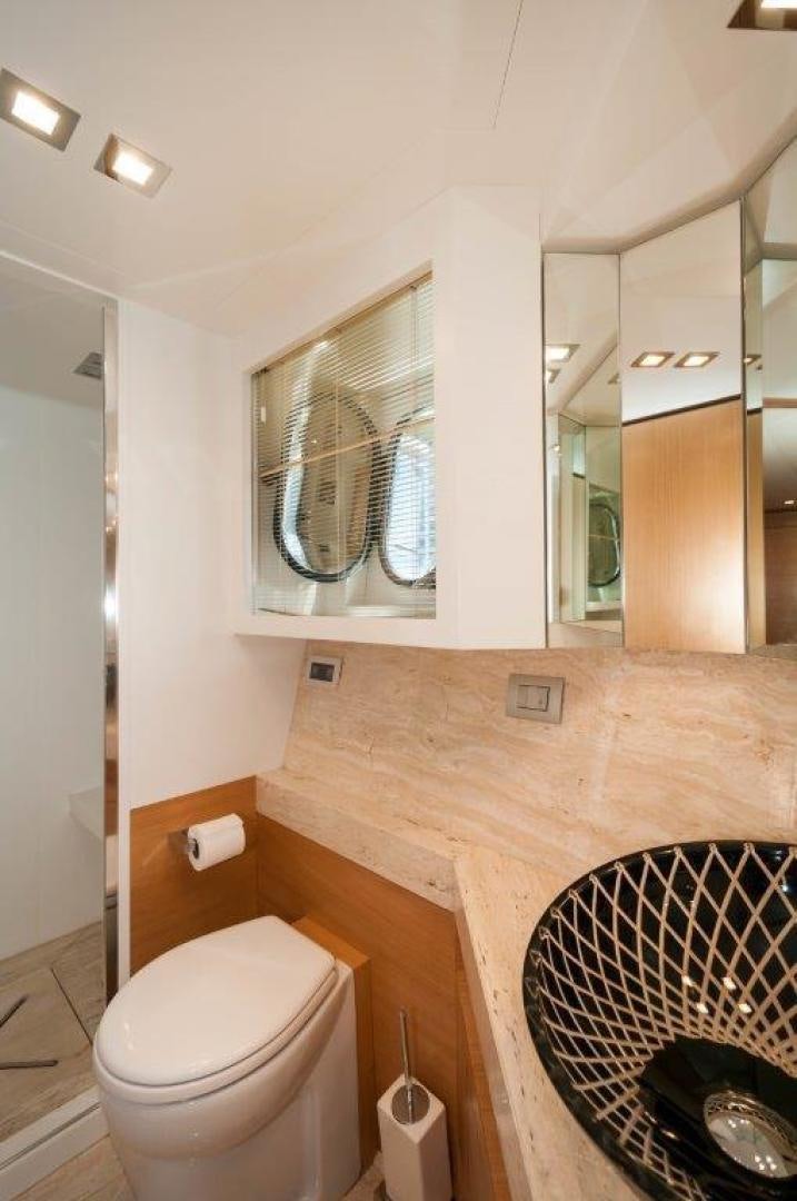 a bathroom with a toilet and a mirror aboard NEVER REST Yacht for Sale