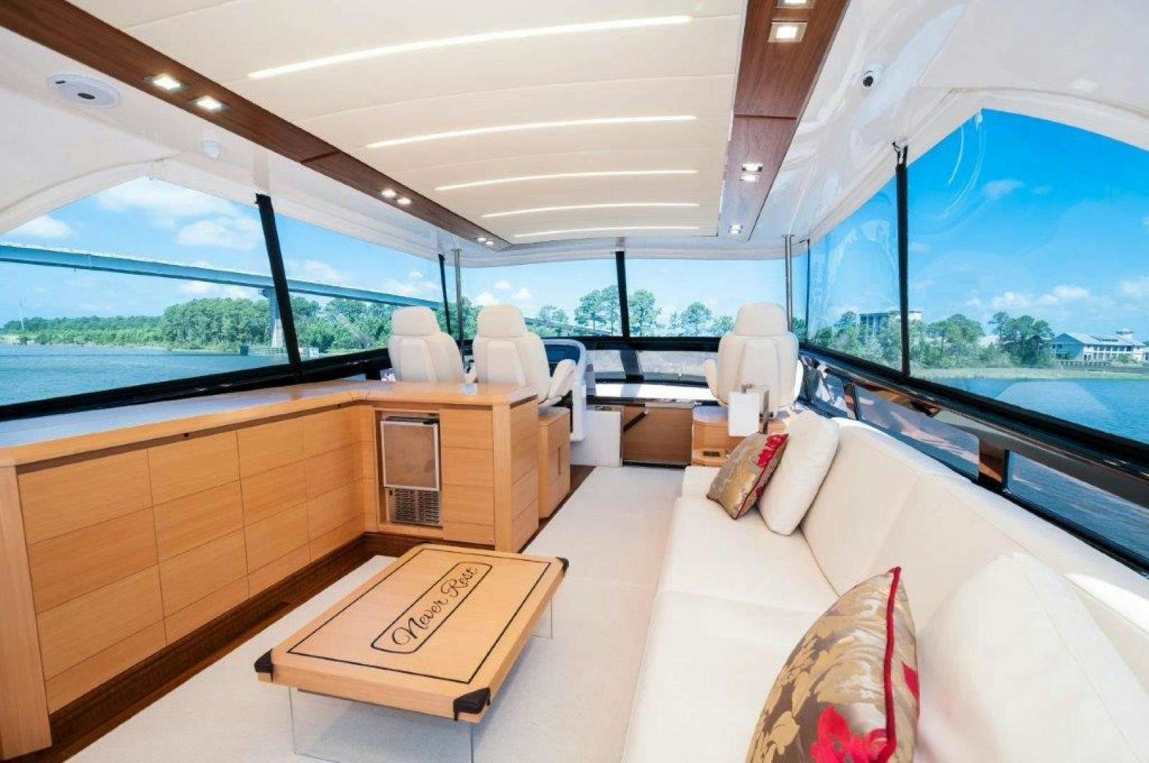a room with a large window and a couch aboard NEVER REST Yacht for Sale