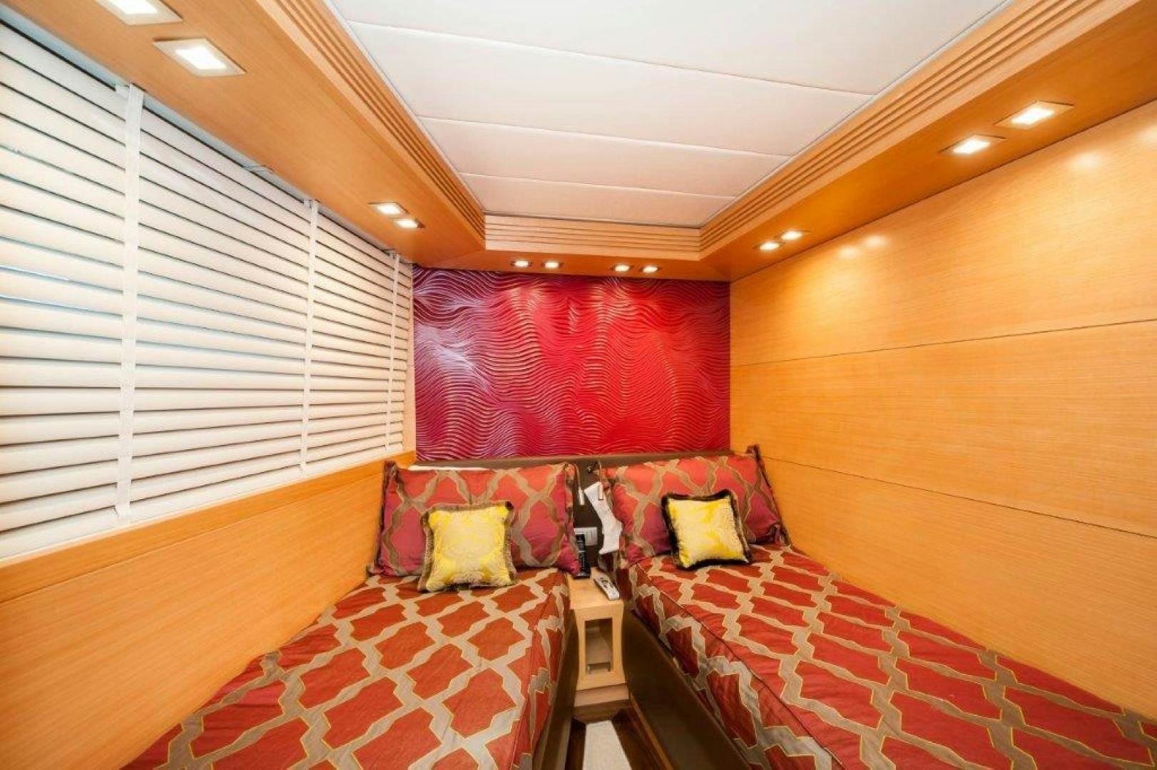 a bedroom with a bed and a window aboard NEVER REST Yacht for Sale