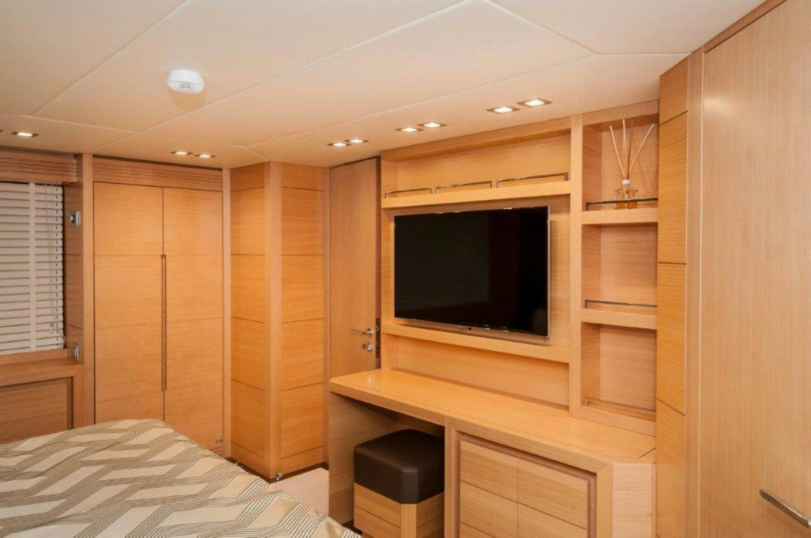 a room with a bed and a tv aboard NEVER REST Yacht for Sale