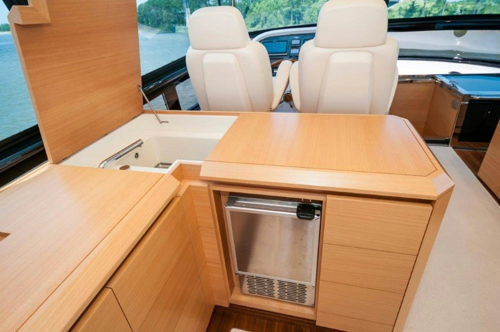 a wooden desk with a silver box on it aboard NEVER REST Yacht for Sale