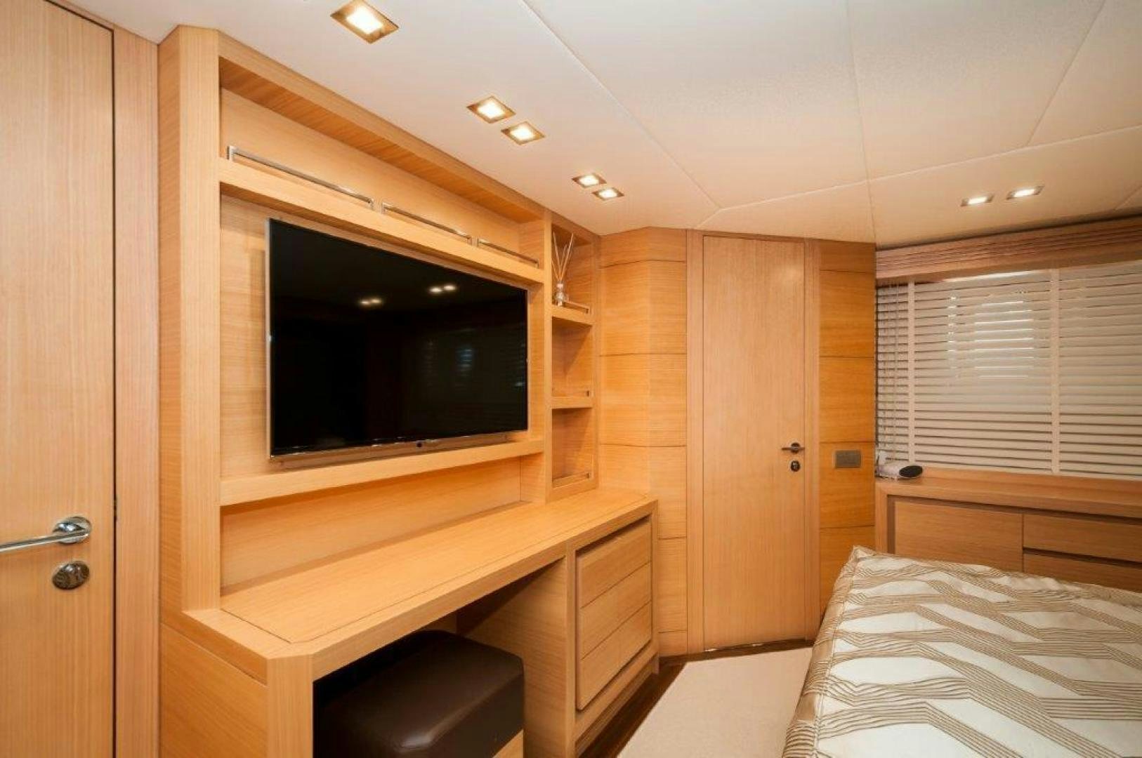 a room with a bed and a television aboard NEVER REST Yacht for Sale