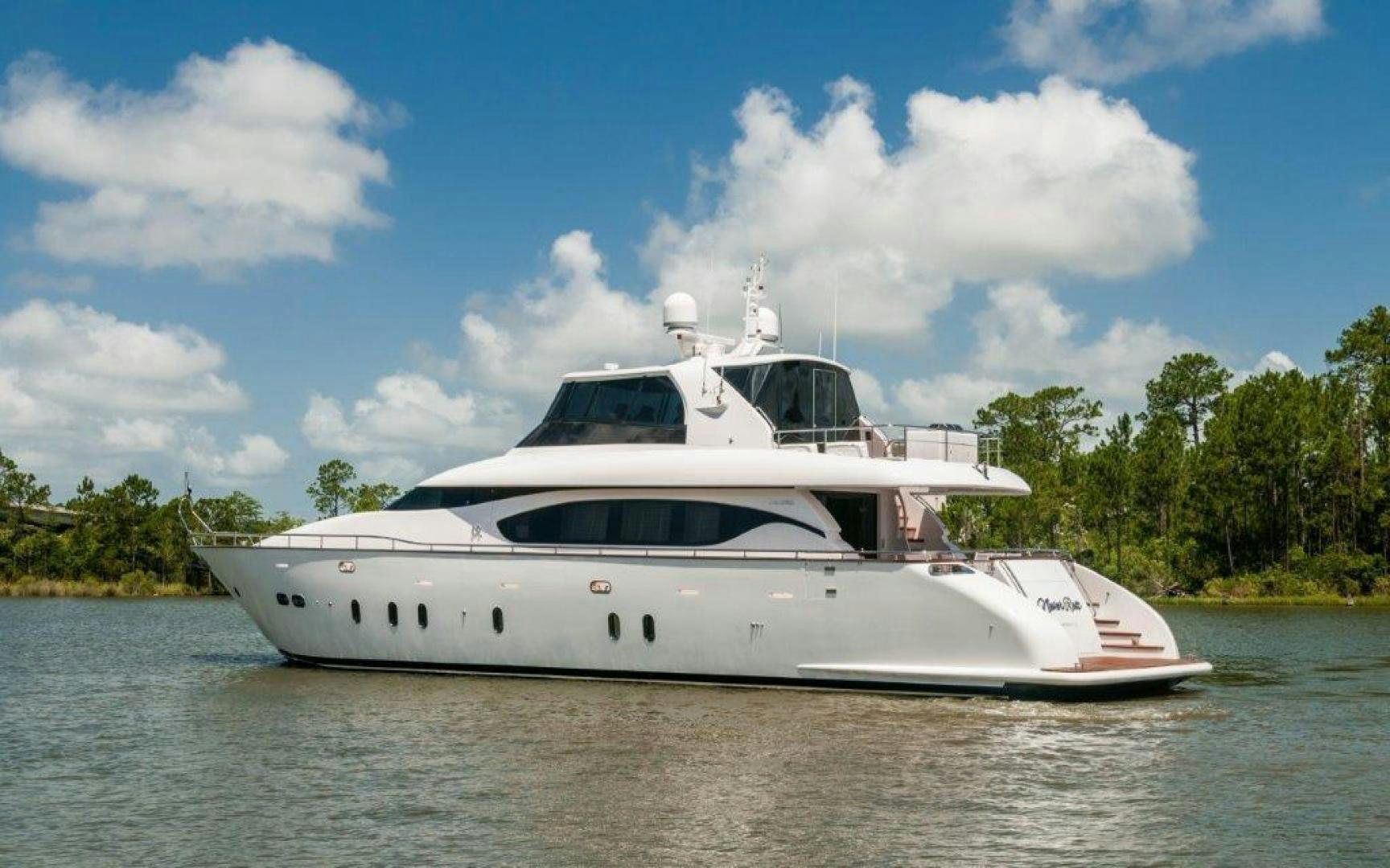 a white yacht on the water aboard NEVER REST Yacht for Sale
