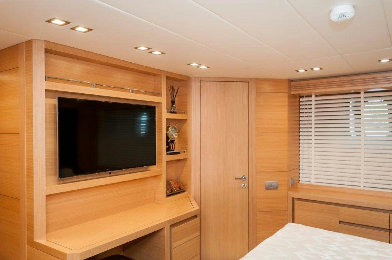 a room with a tv and a bed aboard NEVER REST Yacht for Sale