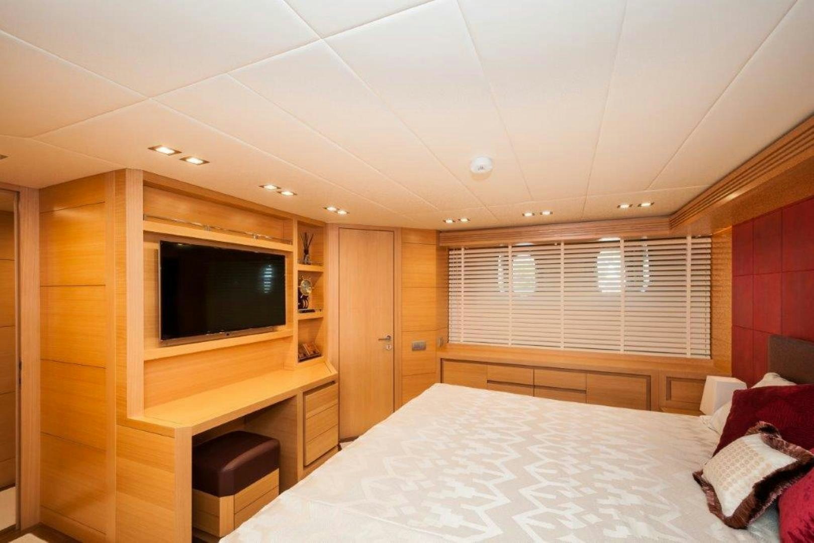 a bedroom with a bed and a tv aboard NEVER REST Yacht for Sale