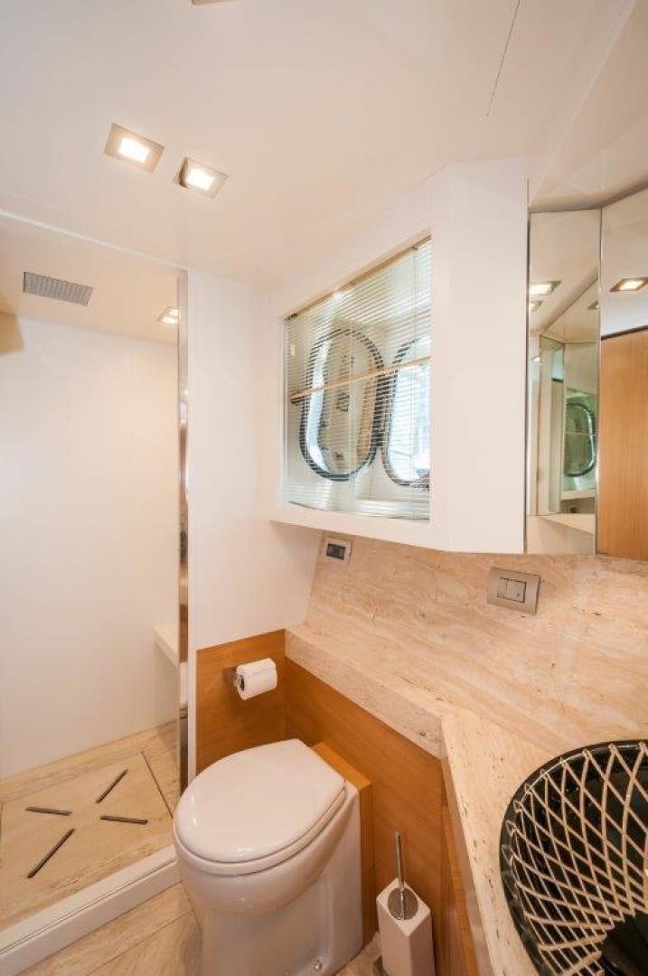 a bathroom with a toilet and a sink aboard NEVER REST Yacht for Sale