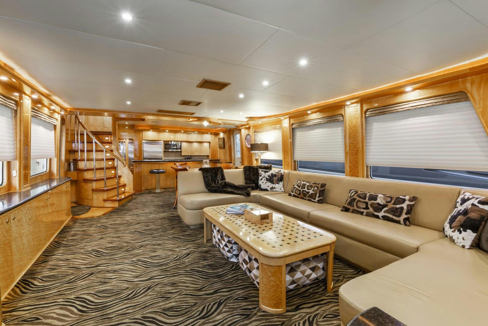 a living room with a large open staircase aboard HOLIDAY Yacht for Sale