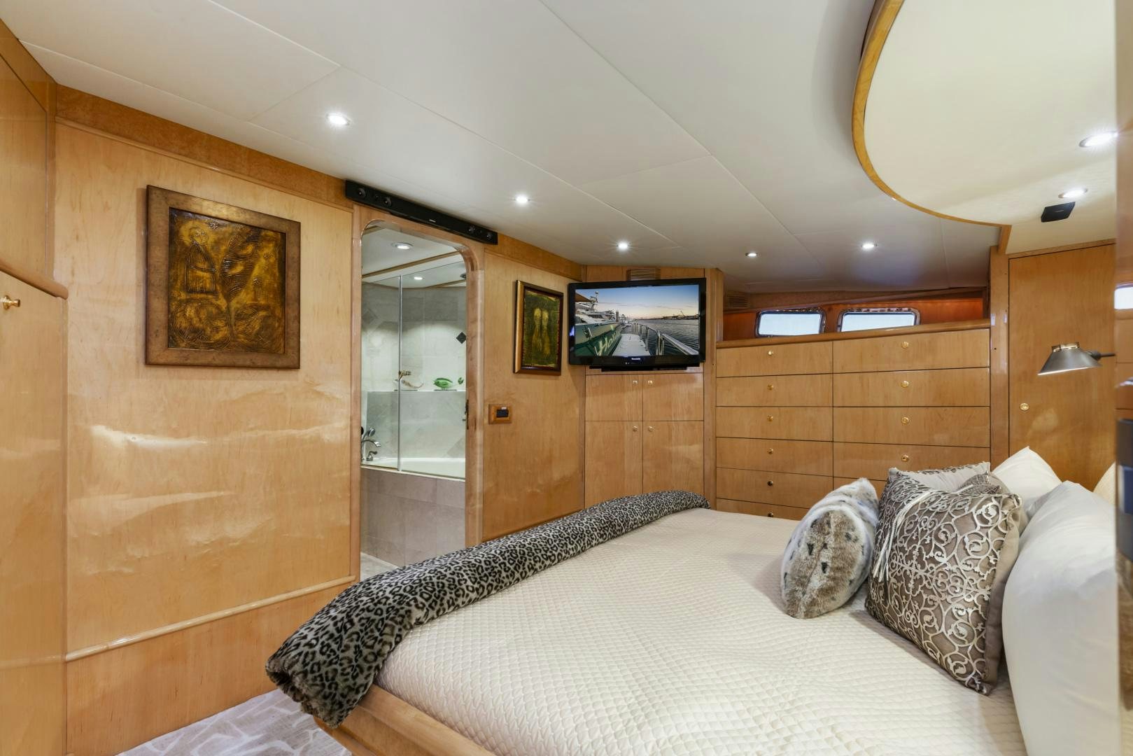 a bedroom with a bed and a television aboard HOLIDAY Yacht for Sale