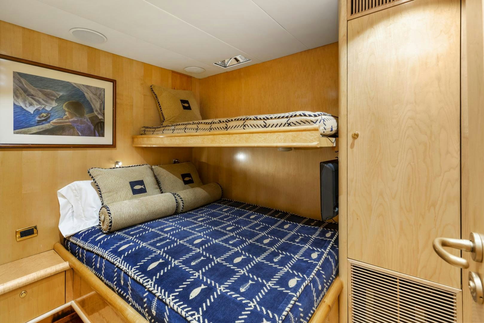 a room with a bed and a television aboard HOLIDAY Yacht for Sale