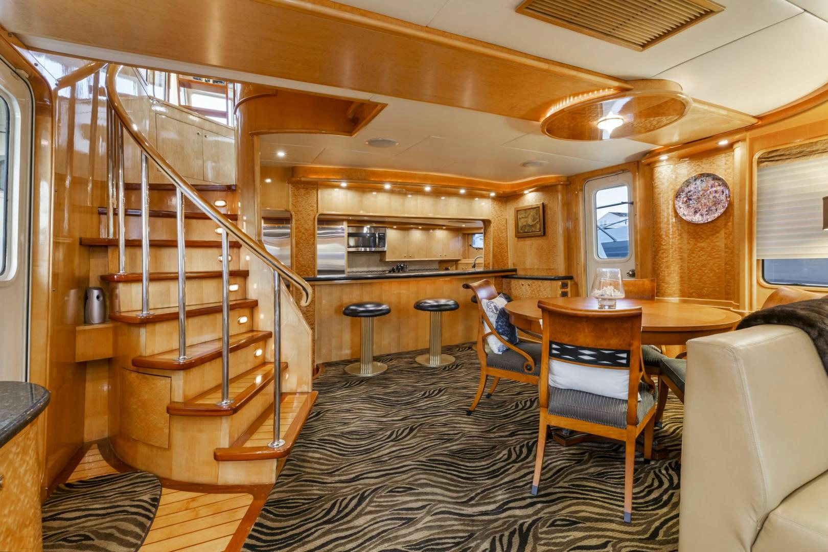 a room with a ladder and chairs aboard HOLIDAY Yacht for Sale