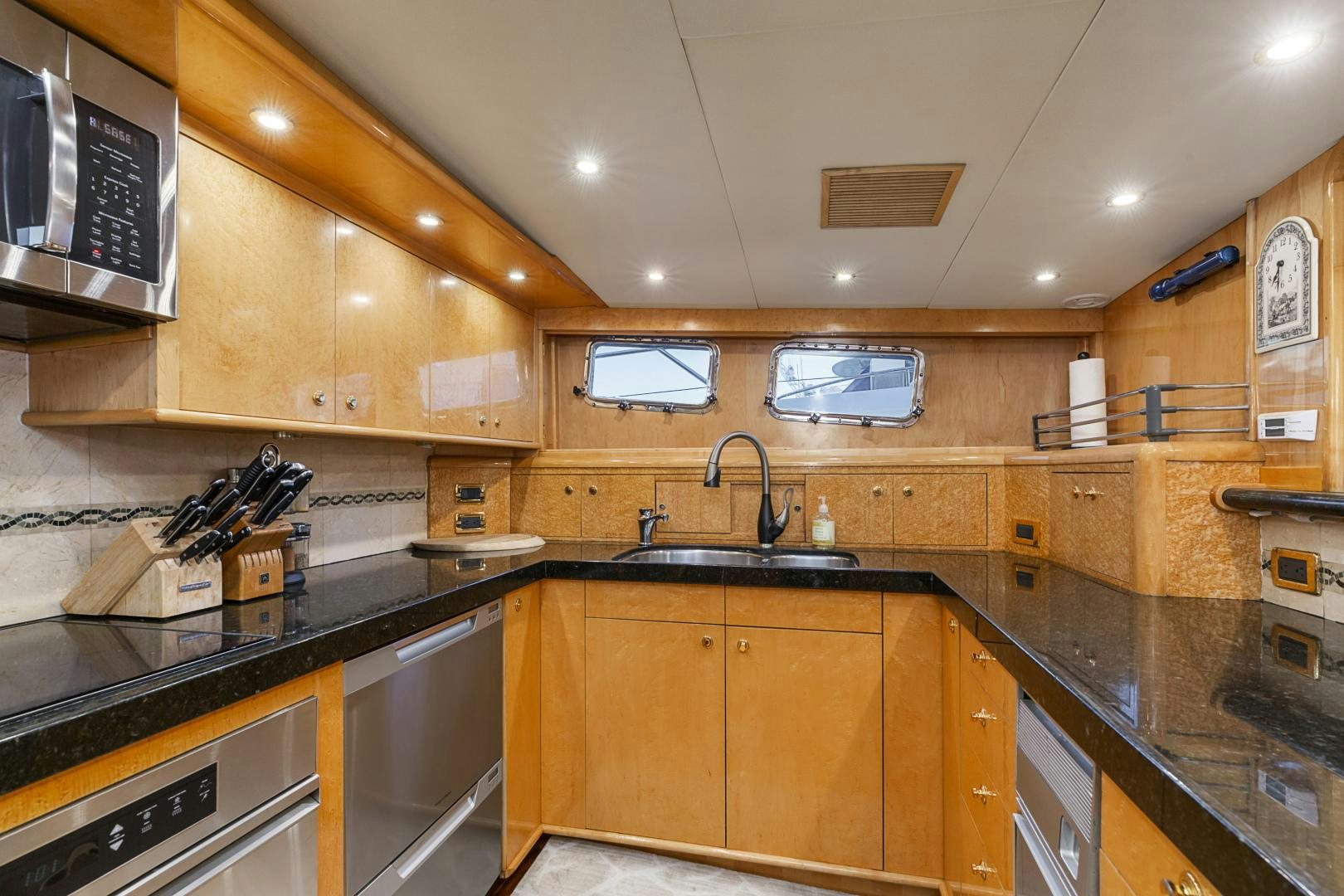 a kitchen with wooden cabinets aboard HOLIDAY Yacht for Sale