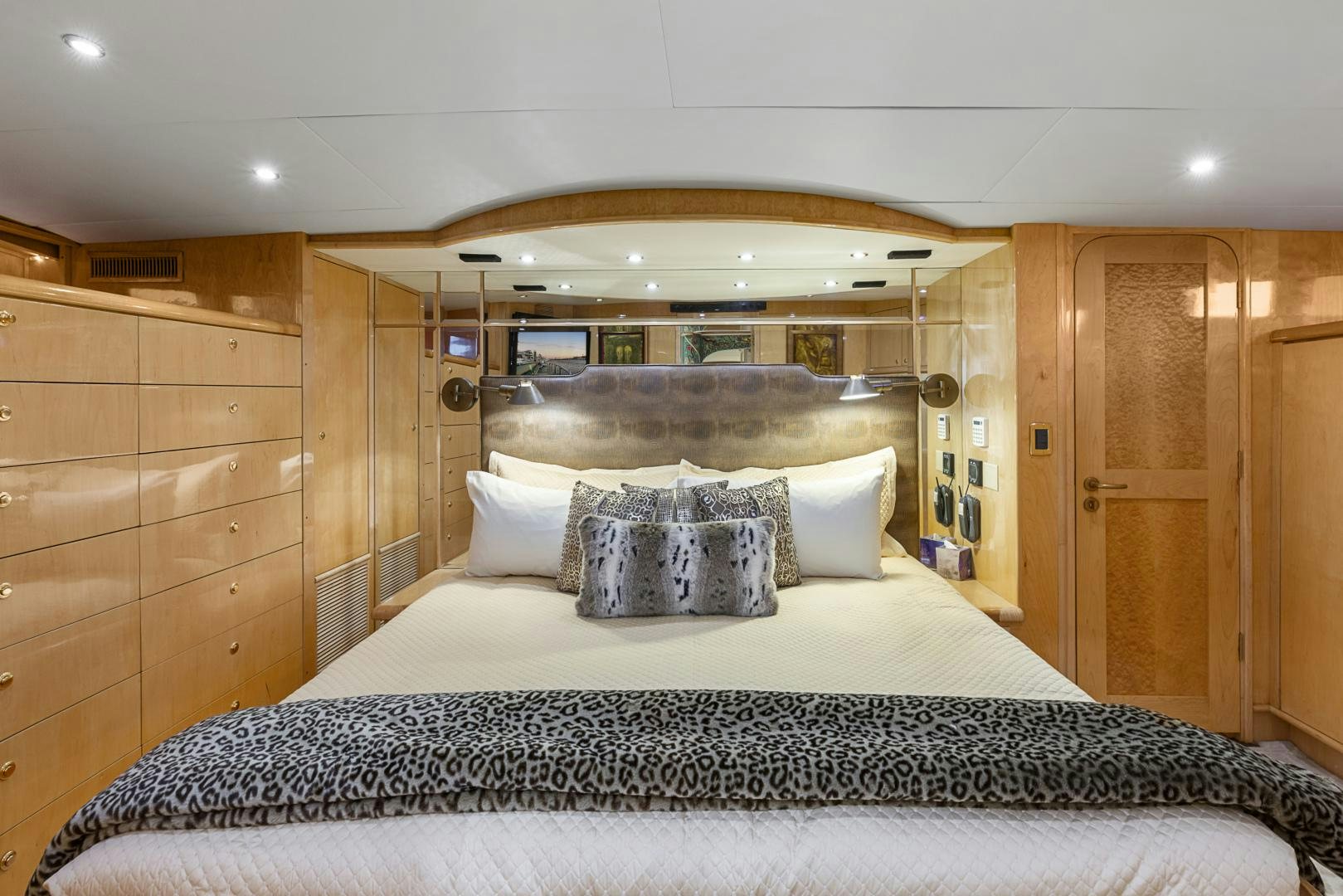 a bed with a mirror above it aboard HOLIDAY Yacht for Sale