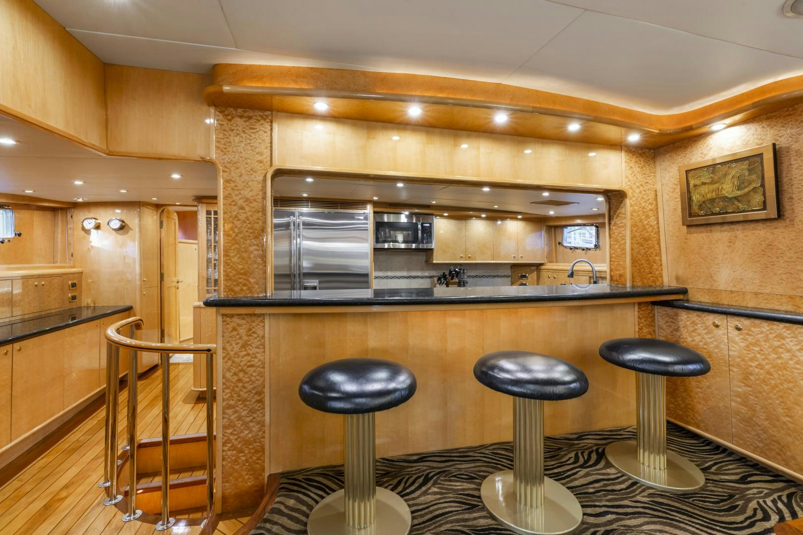 a kitchen with stools and a bar aboard HOLIDAY Yacht for Sale