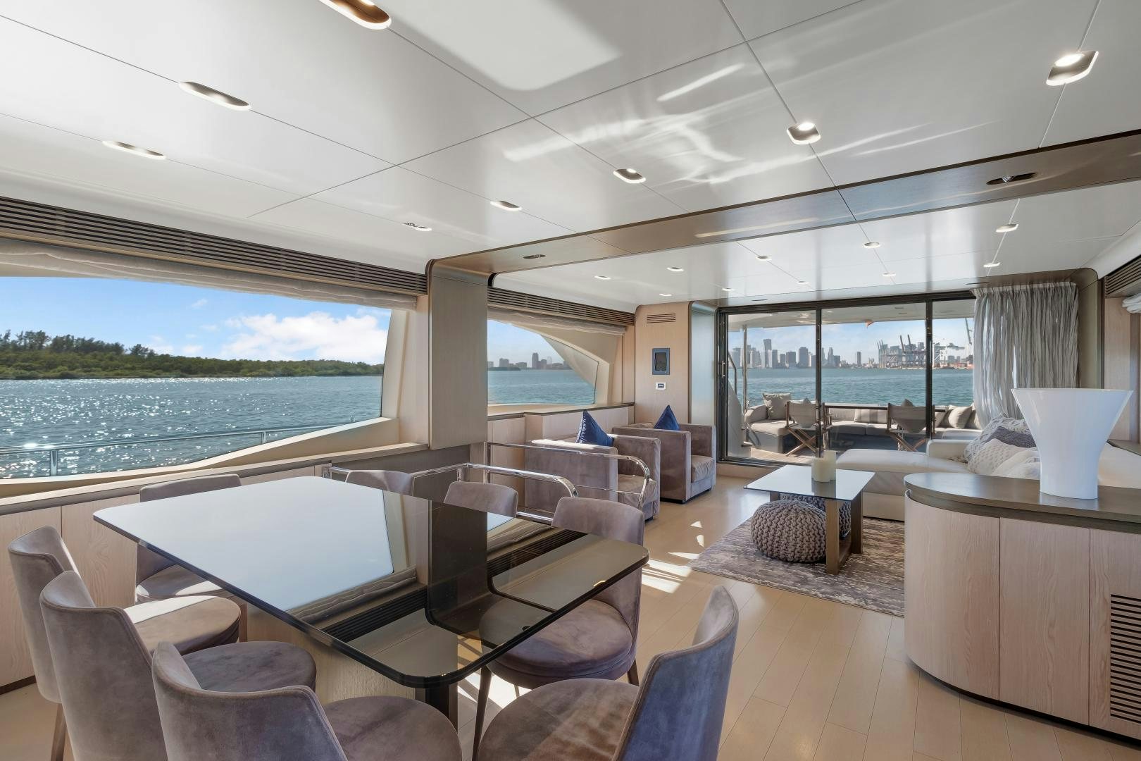 a room with a large table and chairs and a large body of water aboard NO NAME Yacht for Sale