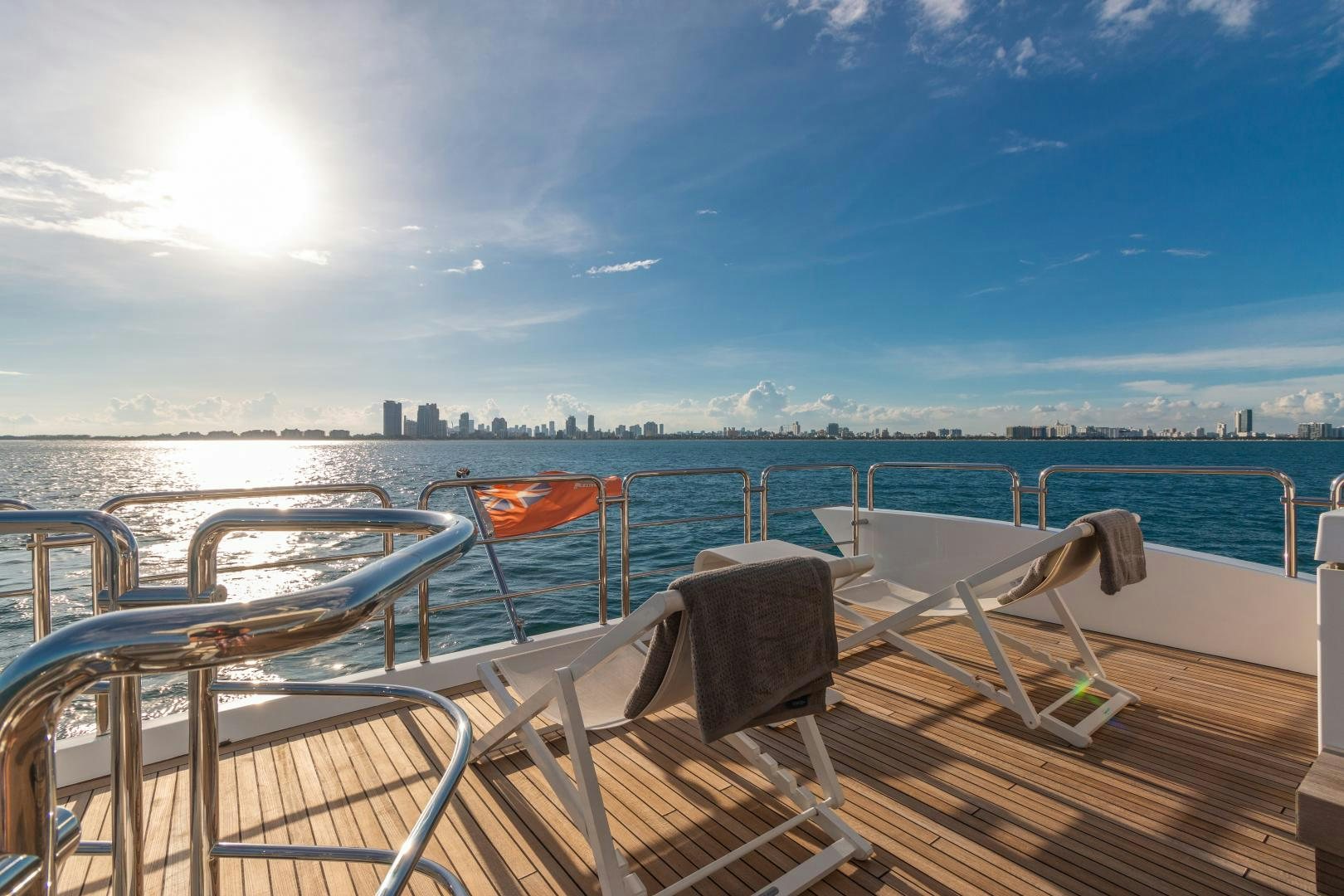 a deck with chairs and a body of water in the background aboard NO NAME Yacht for Sale