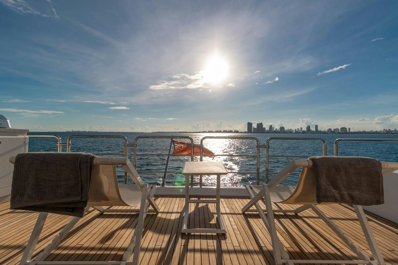 a deck with chairs and a view of the city aboard NO NAME Yacht for Sale