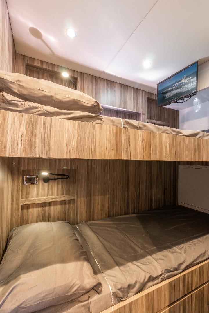 a bed with a television on the wall aboard NO NAME Yacht for Sale
