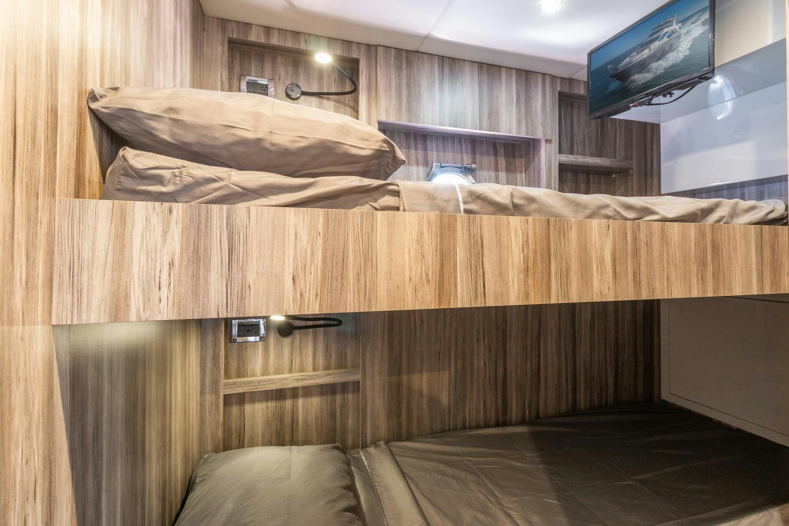 a room with a bed and a television on the wall aboard NO NAME Yacht for Sale