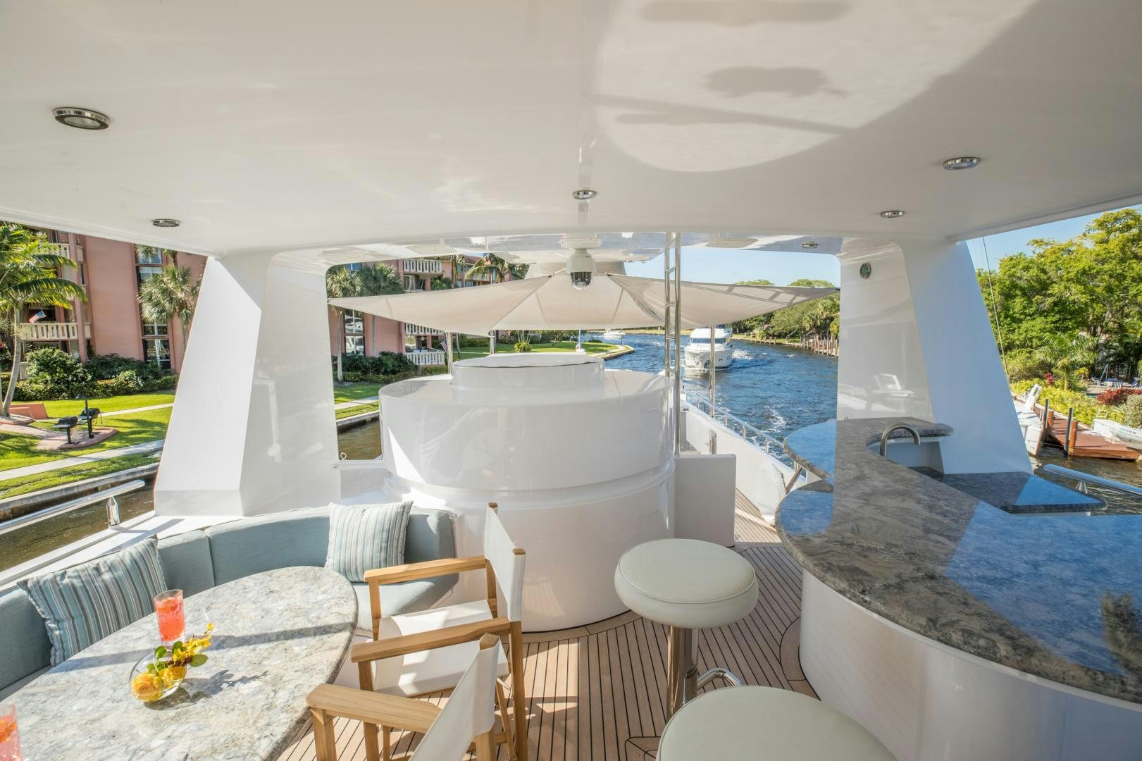 a room with a pool and a table and chairs aboard SLOW POKE Yacht for Sale