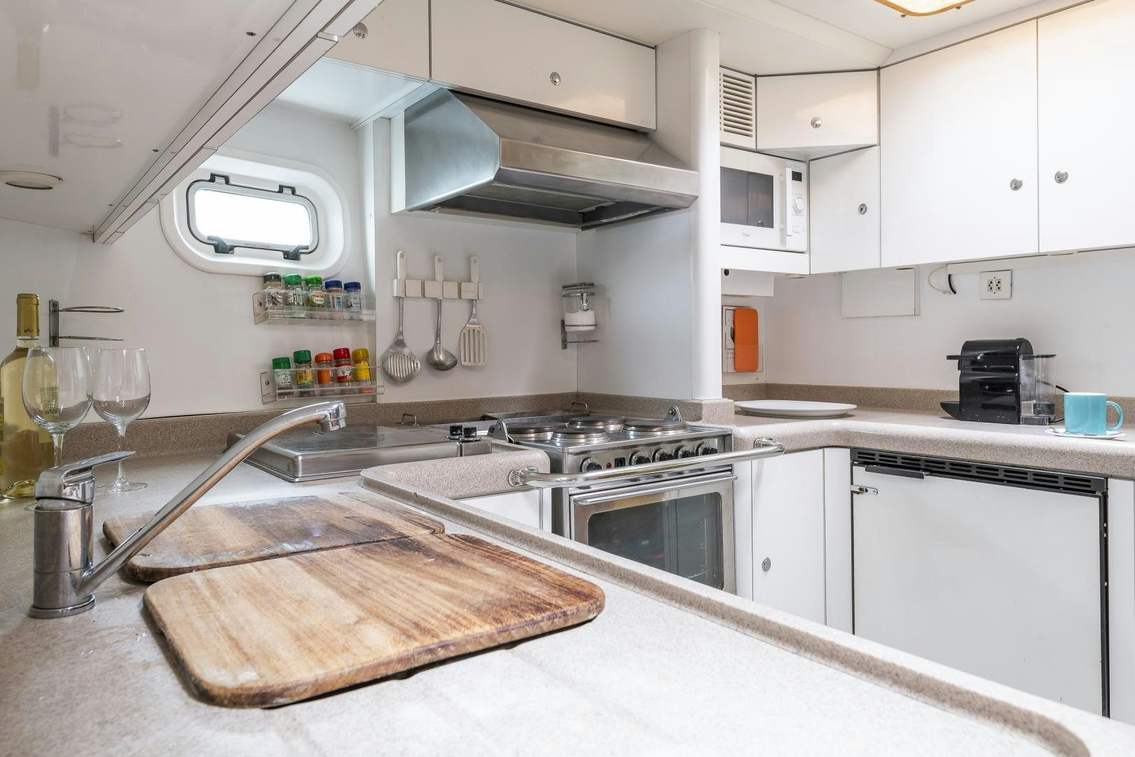 a kitchen with white cabinets aboard ROCIO Yacht for Sale
