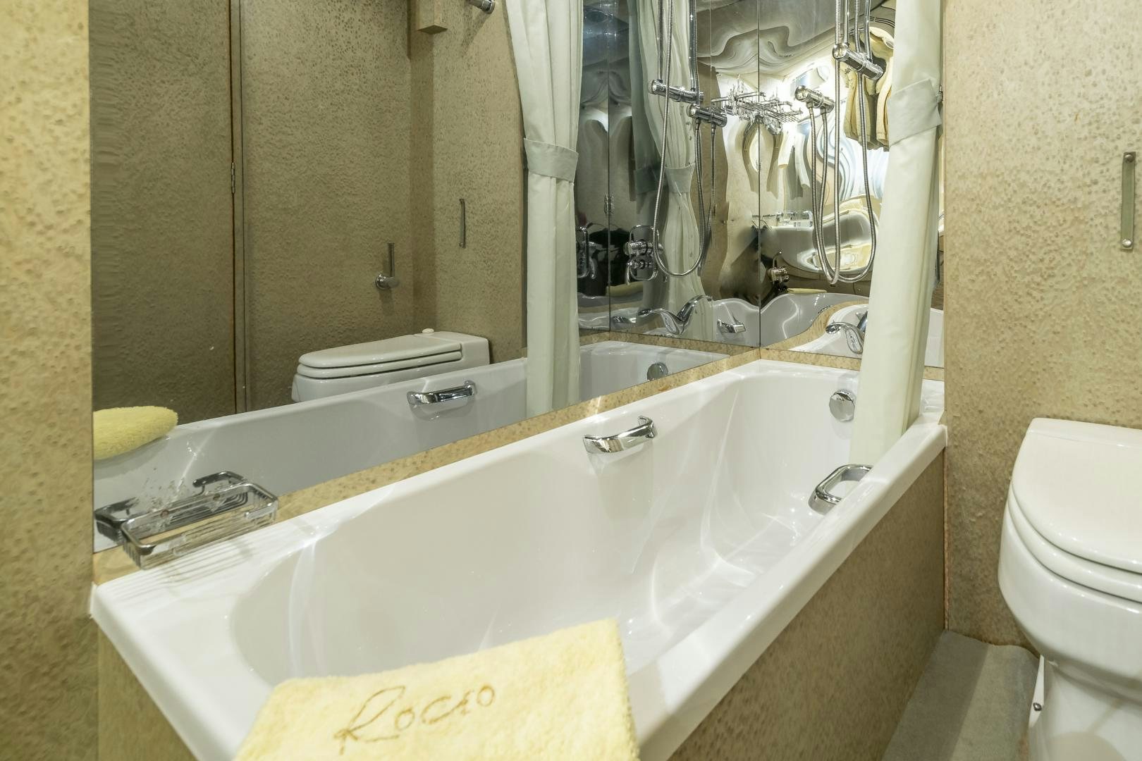 a bathroom with a bathtub and toilet aboard ROCIO Yacht for Sale