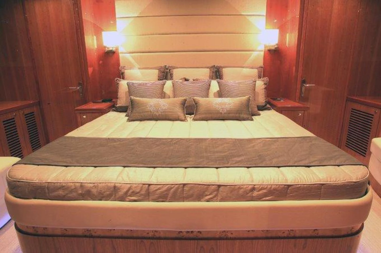 a bed with a black and white comforter and pillows aboard JOHNSON 80' FLYBRIDGE W/FISHING COCKPIT Yacht for Sale