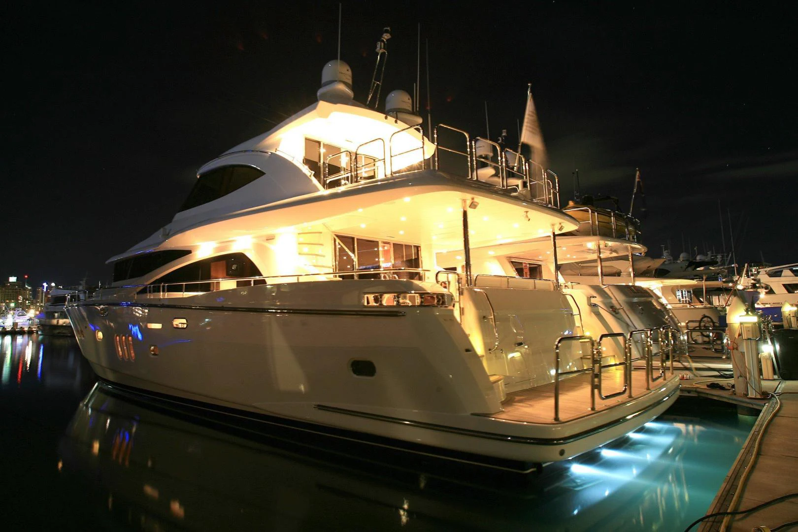 a large white yacht at night aboard JOHNSON 80' FLYBRIDGE W/FISHING COCKPIT Yacht for Sale