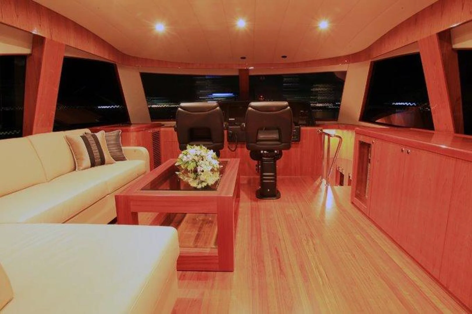 a room with a table and chairs aboard JOHNSON 80' FLYBRIDGE W/FISHING COCKPIT Yacht for Sale
