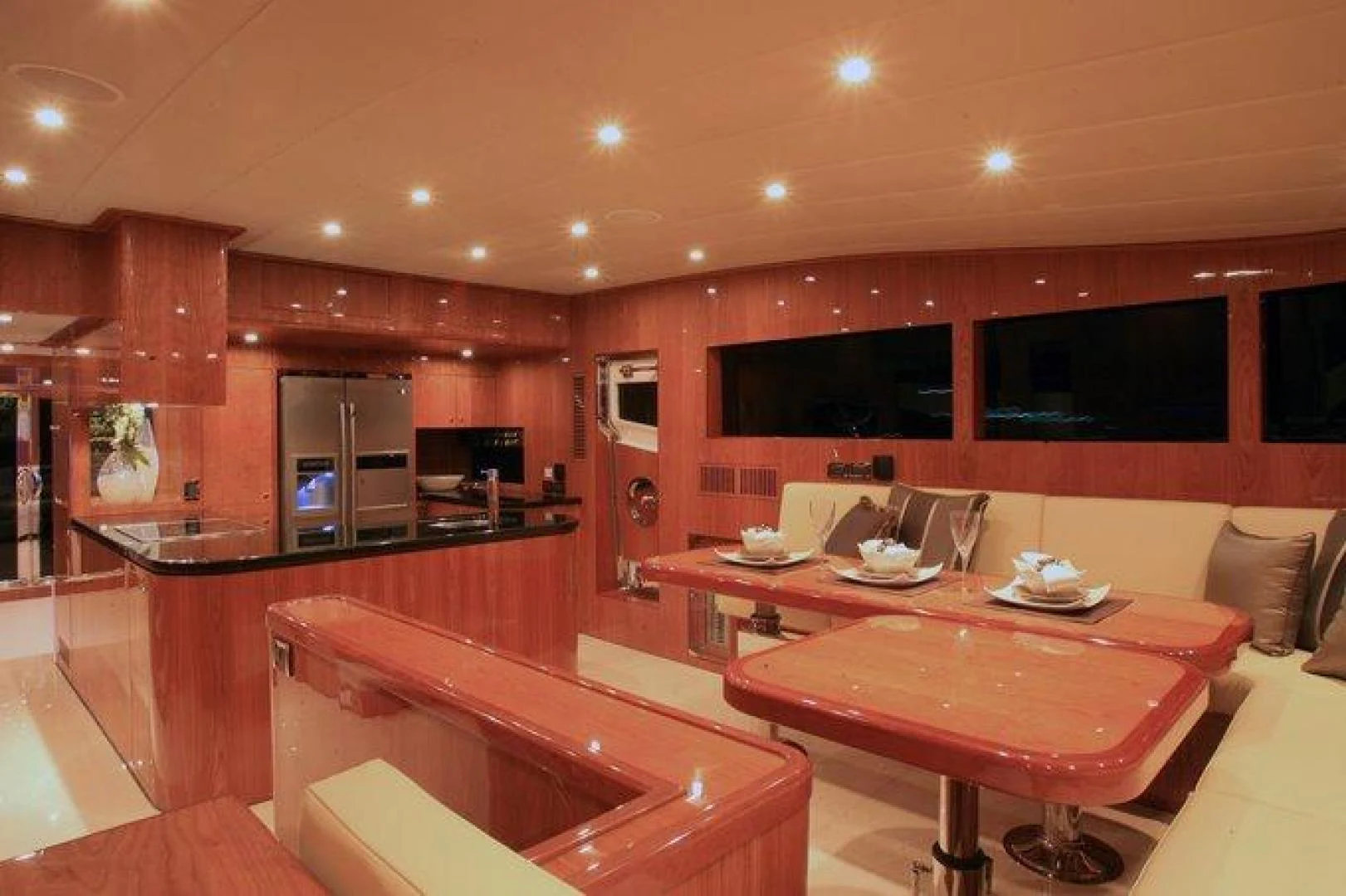 a room with a table and chairs aboard JOHNSON 80' FLYBRIDGE W/FISHING COCKPIT Yacht for Sale