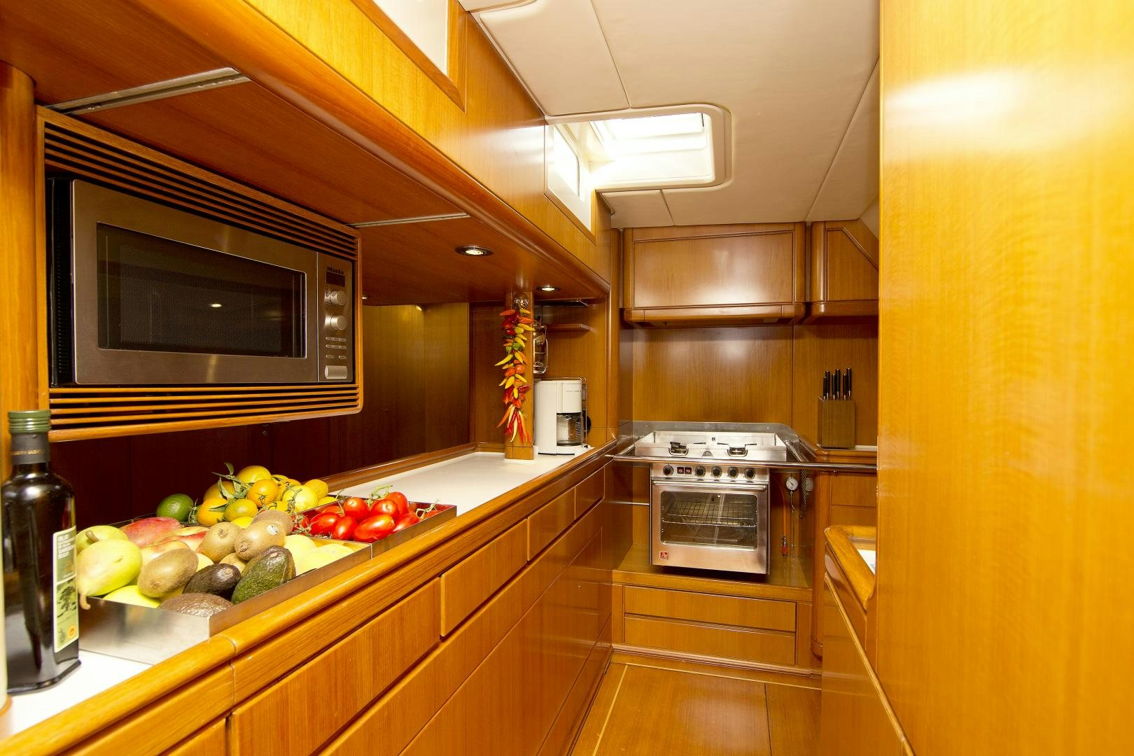a kitchen with fruits and vegetables aboard METOLIUS Yacht for Sale