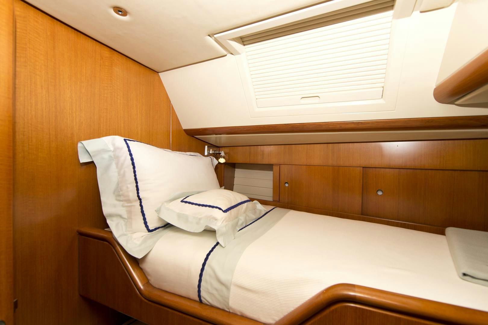 a bed with white sheets aboard METOLIUS Yacht for Sale
