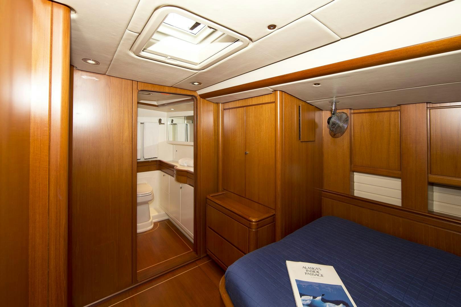 a room with a bed and a desk aboard METOLIUS Yacht for Sale